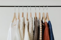 a rack of clothes hanging on clothes hangers