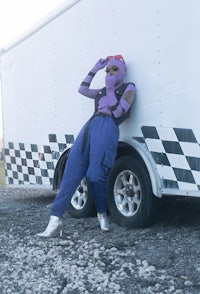 a person leaning against the side of a truck